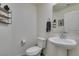 Clean half bathroom featuring a pedestal sink, mirror, and modern fixtures at 10939 Cheshire Woods Ave, Las Vegas, NV 89166