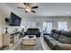 Inviting living room with a modern ceiling fan and sliding glass doors to the backyard at 10939 Cheshire Woods Ave, Las Vegas, NV 89166