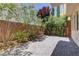Outdoor patio with lush landscaping surrounding the brick-laid area at 11377 Gravitation Dr, Las Vegas, NV 89135