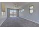 Spacious carpeted bedroom with multiple windows allowing for beautiful natural light and a sliding door to a balcony at 11377 Gravitation Dr, Las Vegas, NV 89135