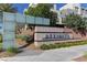 Elegant community entrance with modern signage, lush landscaping, and a welcoming pathway at 11377 Gravitation Dr, Las Vegas, NV 89135