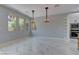 Dining room features marble floors, backyard view, and stylish light fixtures near the kitchen at 11377 Gravitation Dr, Las Vegas, NV 89135