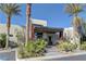 Inviting home entrance with a covered porch, modern design, and desert-friendly landscaping at 11377 Gravitation Dr, Las Vegas, NV 89135