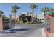 Striking exterior of a modern home, framed by mature palm trees and an elegant gated entrance at 11377 Gravitation Dr, Las Vegas, NV 89135