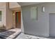 Townhome entrance featuring stone steps, modern lighting, stucco walls, and neutral trim at 11377 Gravitation Dr, Las Vegas, NV 89135