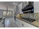 Bright kitchen with white cabinets, stainless appliances, and tile backsplash at 11377 Gravitation Dr, Las Vegas, NV 89135