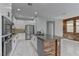 Modern kitchen has white cabinets, island, stainless steel appliances, and tile floors at 11377 Gravitation Dr, Las Vegas, NV 89135