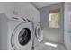 Laundry room with side-by-side Samsung washer and dryer and storage cabinets at 11377 Gravitation Dr, Las Vegas, NV 89135