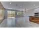 Spacious living room includes marble floors, wood-look accent wall, and backyard access at 11377 Gravitation Dr, Las Vegas, NV 89135