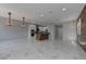Open floor plan with island, marble tile, recessed lighting, and wood accent wall at 11377 Gravitation Dr, Las Vegas, NV 89135