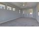Bright and spacious living room with plush carpeting and a ceiling fan at 11377 Gravitation Dr, Las Vegas, NV 89135