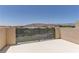 Outdoor patio with perimeter fencing with views of the mountains in the distance at 11377 Gravitation Dr, Las Vegas, NV 89135