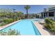 Resort-style community pool area with sparkling water, ample lounge seating, and lush greenery at 11377 Gravitation Dr, Las Vegas, NV 89135