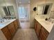 This bathroom has dual vanities, a soaking tub, and modern fixtures at 1146 Olivia Pkwy, Henderson, NV 89011