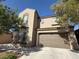 Exterior elevation of a two story home with attached two car garage and stucco facade at 1146 Olivia Pkwy, Henderson, NV 89011