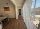 Hallway with view to the backyard, tiled floor, neutral color, and sheer curtains offering privacy at 1146 Olivia Pkwy, Henderson, NV 89011
