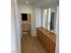 Hallway with built-in cabinets, wood-look floors and a laundry room at 1146 Olivia Pkwy, Henderson, NV 89011