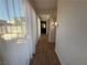 Hallway with tile flooring and view to the backyard with sheer curtains on glass sliding door at 1146 Olivia Pkwy, Henderson, NV 89011
