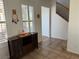 Comfortable living room with natural light, tile flooring, and a stylish display cabinet at 1146 Olivia Pkwy, Henderson, NV 89011