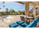 Backyard oasis with patio furniture, palm trees, rock waterfall, and lush landscaping at 1239 N Hollywood Blvd, Las Vegas, NV 89110
