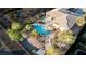 Aerial view showcases backyard, pool area, lush landscaping, and desert surroundings at 1239 N Hollywood Blvd, Las Vegas, NV 89110