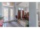 Inviting entryway with decorative glass doors leading to a dining area with chandelier and elegant furnishings at 1239 N Hollywood Blvd, Las Vegas, NV 89110