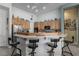 Bright and open kitchen with wood cabinetry and a breakfast bar at 1239 N Hollywood Blvd, Las Vegas, NV 89110