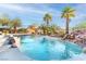 A luxurious backyard pool with a rock waterfall feature surrounded by desert landscaping at 1239 N Hollywood Blvd, Las Vegas, NV 89110