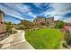 Beautifully landscaped backyard with green lawn and walking path, perfect for outdoor enjoyment at 15 Santo Mio Ct, Henderson, NV 89011