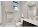 Well-lit bathroom with a white toilet, vanity, and a window with a shade at 15 Santo Mio Ct, Henderson, NV 89011
