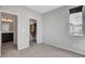 Bright bedroom features neutral walls, carpet, a window and a closet with clothes inside at 15 Santo Mio Ct, Henderson, NV 89011