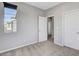 Neutral-toned bedroom featuring a window and two entry doors at 15 Santo Mio Ct, Henderson, NV 89011