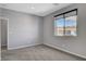Well-lit bedroom with view of neighborhood, neutral walls and carpet at 15 Santo Mio Ct, Henderson, NV 89011