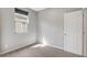 A neutral-toned bedroom featuring a window and a white door at 15 Santo Mio Ct, Henderson, NV 89011
