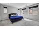 Bright bedroom with three windows, carpet flooring, and a dark bed frame topped with blue comforter at 15 Santo Mio Ct, Henderson, NV 89011