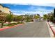 Community gate surrounded by lush landscaping, providing a secure and welcoming entrance at 15 Santo Mio Ct, Henderson, NV 89011