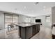 Spacious open-concept kitchen boasts a large island with a dishwasher, leading to a dining area and living room at 15 Santo Mio Ct, Henderson, NV 89011