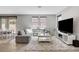 Inviting living room featuring gray sofa and large TV at 15 Santo Mio Ct, Henderson, NV 89011