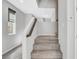 Carpeted staircase with white walls and a modern design, leading to the upper level of the home at 15 Santo Mio Ct, Henderson, NV 89011