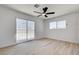 Bedroom with light wood-look floors, a ceiling fan, and a sliding glass door at 1641 K St, Las Vegas, NV 89106