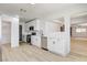 Bright kitchen with white cabinets, stainless steel appliances, and modern light wood flooring at 1641 K St, Las Vegas, NV 89106