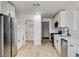 Bright kitchen with white cabinets, stainless steel appliances, and modern light wood flooring at 1641 K St, Las Vegas, NV 89106