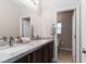 Bathroom featuring a double vanity and a door leading to the toilet at 176 Dunblane St, Henderson, NV 89012