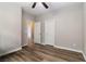 Bedroom with hardwood flooring, white trim, ceiling fan, and multiple doors at 176 Dunblane St, Henderson, NV 89012