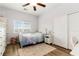 This bedroom features a ceiling fan, a window, and a closet with white sliding doors at 176 Dunblane St, Henderson, NV 89012