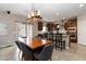 Stylish dining area featuring a wooden table, modern chairs, elegant lighting, and open access to the kitchen at 176 Dunblane St, Henderson, NV 89012