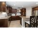 Modern kitchen features granite countertops, stainless steel appliances, and dark wood cabinets at 176 Dunblane St, Henderson, NV 89012