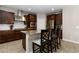 Beautiful kitchen with granite counters, tile flooring, stainless appliances, and modern dark wood cabinetry at 176 Dunblane St, Henderson, NV 89012