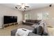 Comfortable living room featuring a plush sectional sofa, entertainment center, and cozy ambiance for relaxation at 176 Dunblane St, Henderson, NV 89012