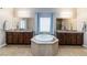 Main bathroom with double sinks, a tub, and a window for natural light at 176 Dunblane St, Henderson, NV 89012